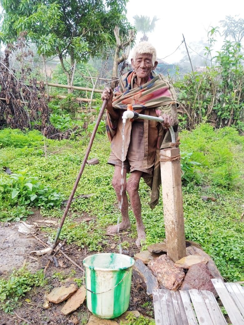 90 years old Meshang from Nokhu village under Noklak district collecting potable water from the pipe supplied by JJM under PHED. (DIPR Photo)